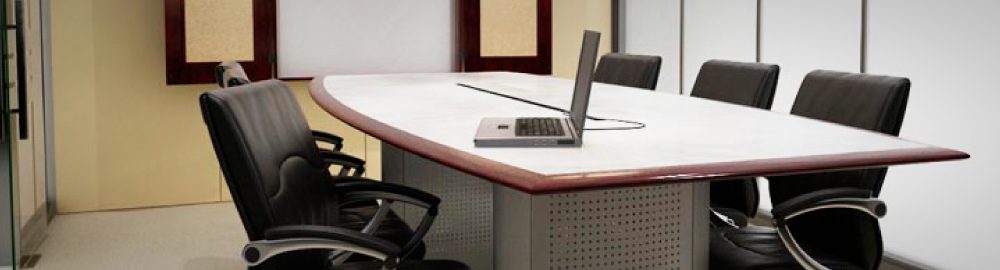 Photo of a chair at a desk facing a laptop